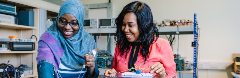 Two female students working in electrical engineering lab