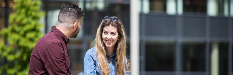 two students talking outside of the Liberty Building