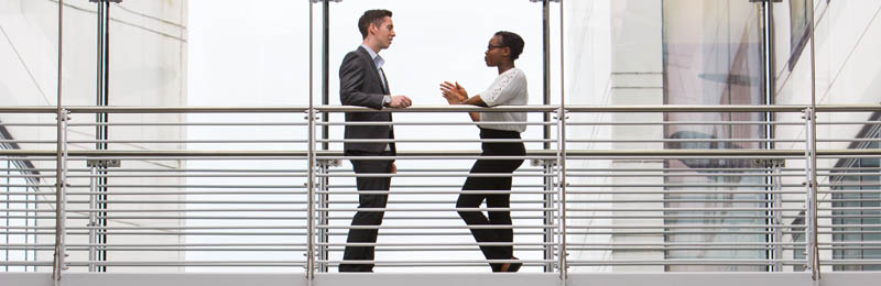 man and women talking in office building