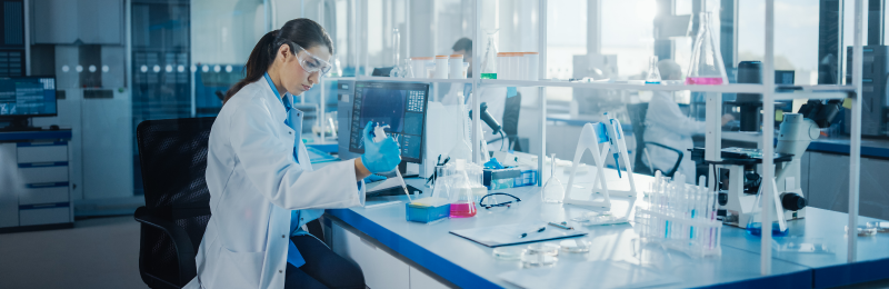Modern Medical Research Laboratory: Female Scientist Working with Pipette, Analysing Biochemicals Samples