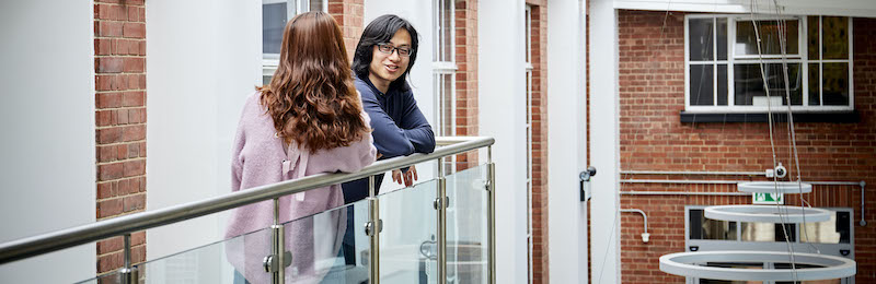 Students chatting on balcony