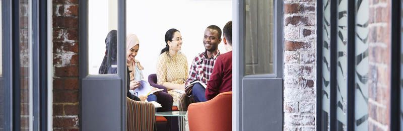 students talking in a group study space