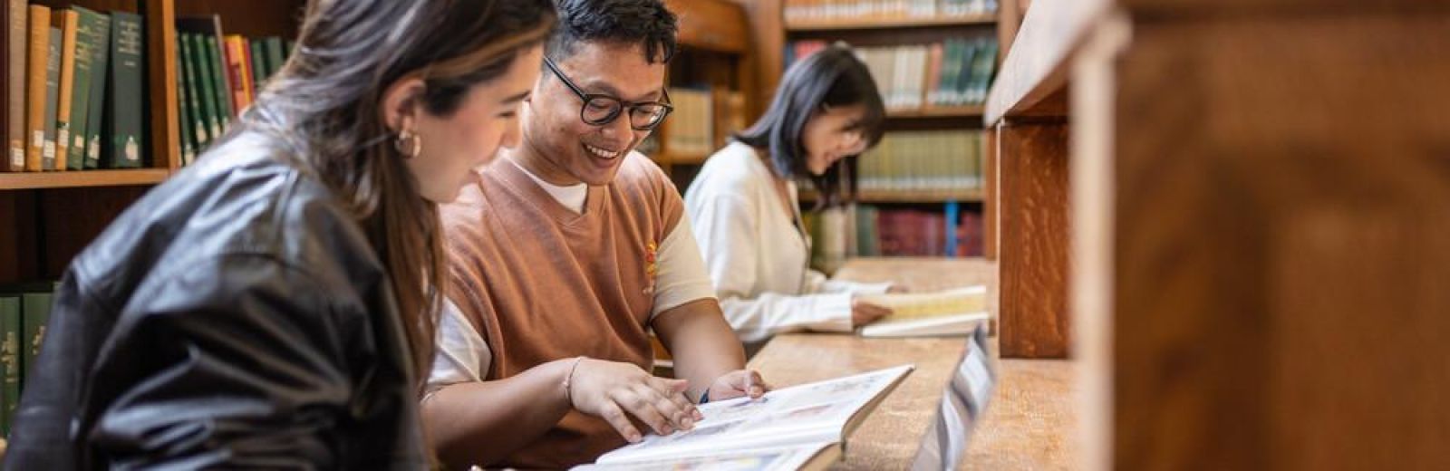 Students talking and reading in the Brotherton library.