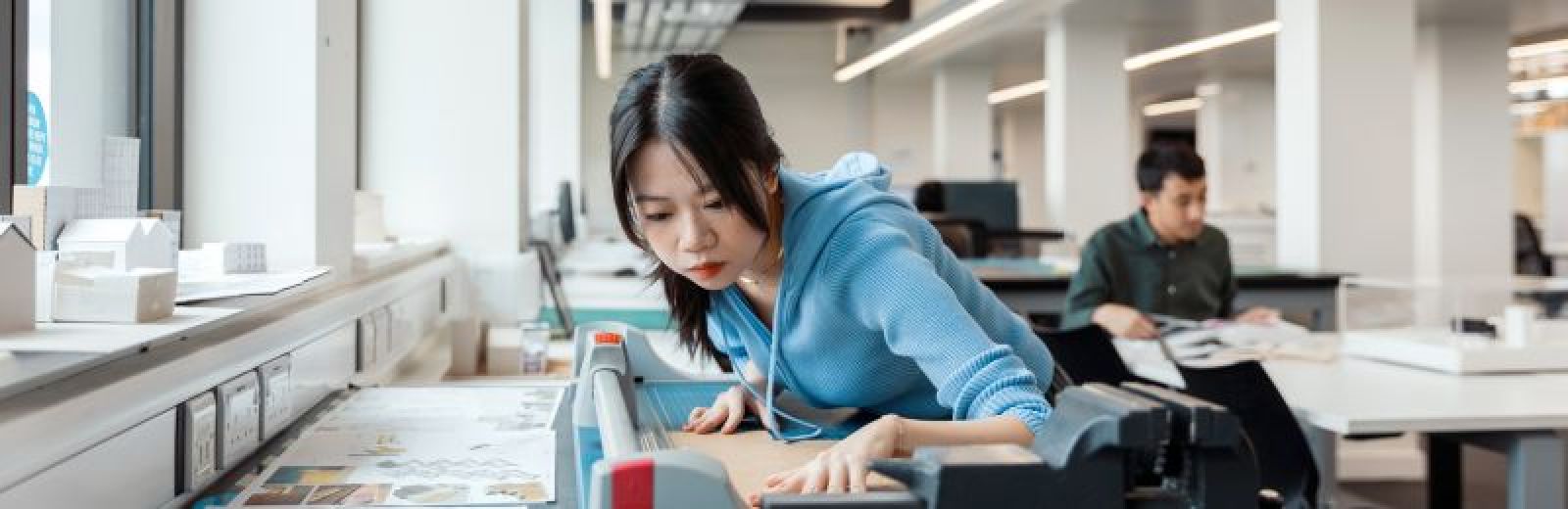 Image of an architecture student using equipment in the design studio.