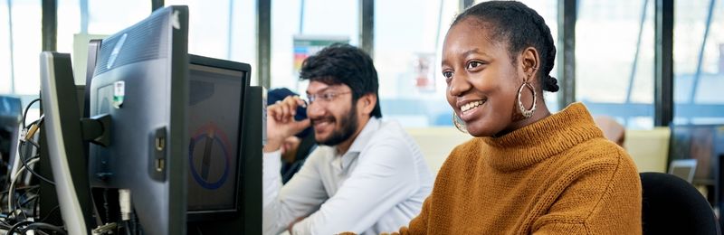 Computing students looking at computer screen