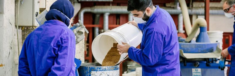 Image of a female and male student working in the structures and materials lab in the School of Civil Engineering at the university of leeds