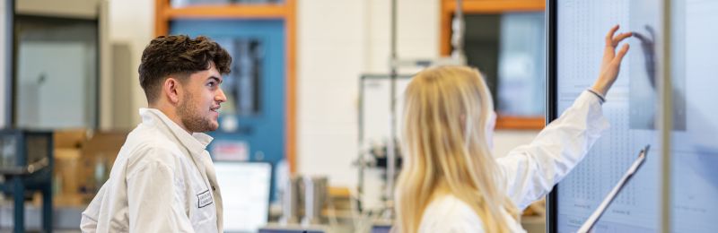 Image of two students working in the civil engineering lab at the University of Leeds.