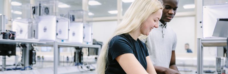 A cropped image of two students working in the NXP Lab at the University of Leeds.