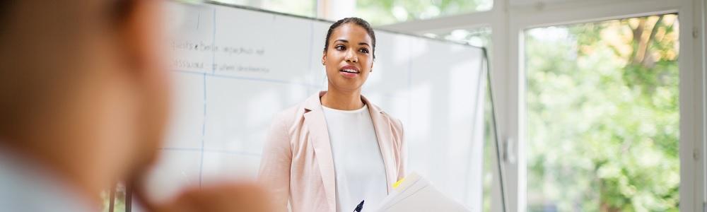 Person standing in front of a whiteboard.