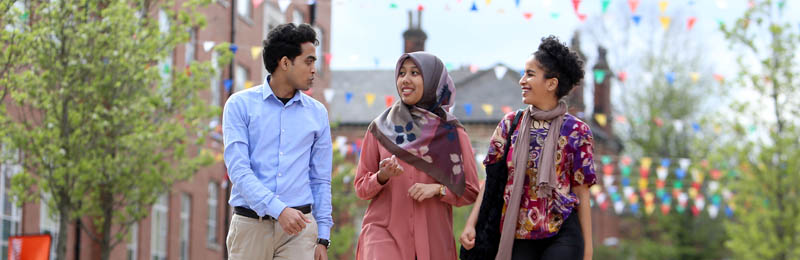 Three students walking outside of the Students' Union