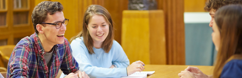 two students talking in the library