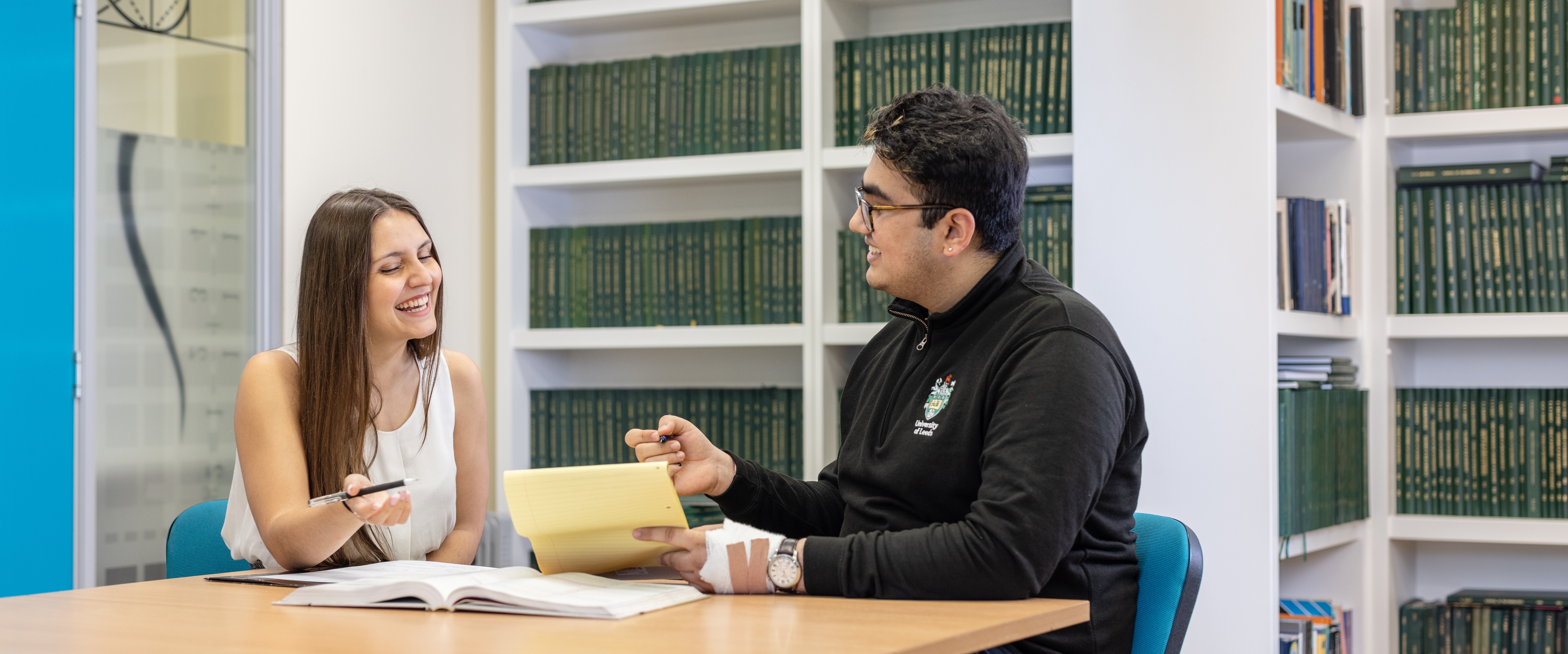 Two students discussing an assignment in the maths reading room
