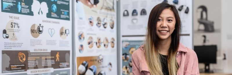 A Product Design student sat in front of her stall at the degree show.