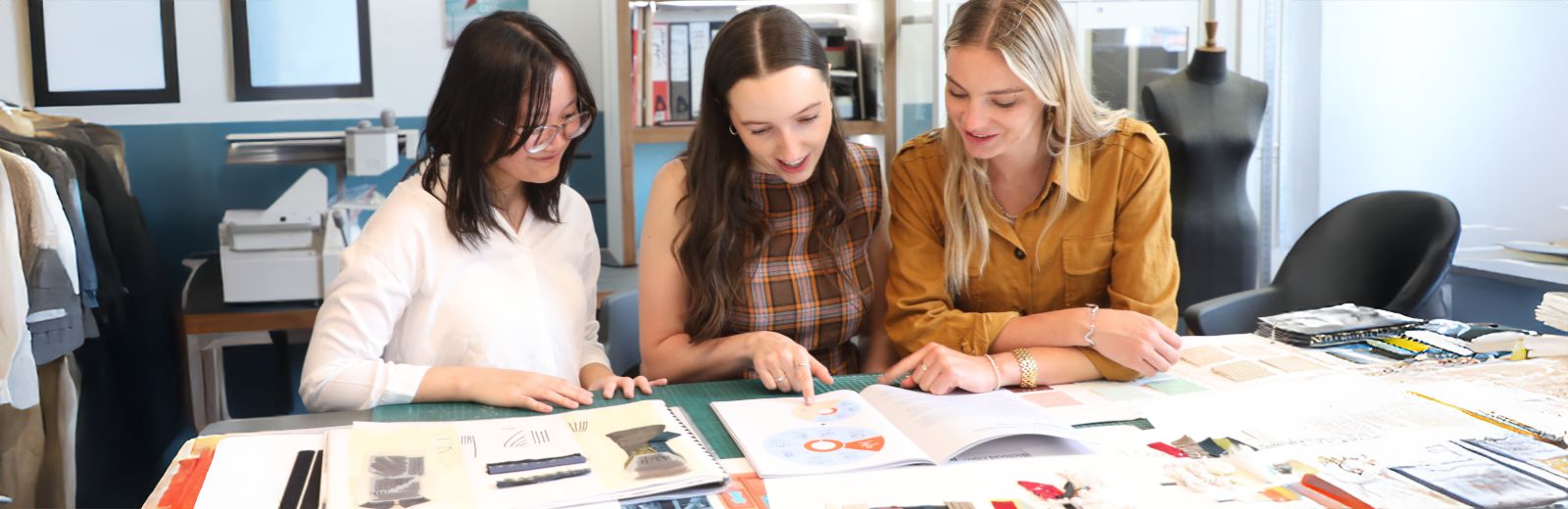 A group of students reviewing designs