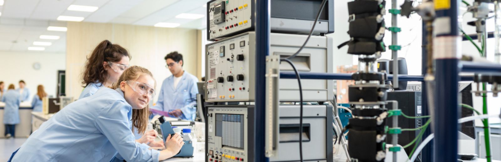 Students using chemical engineering equipment in the lab