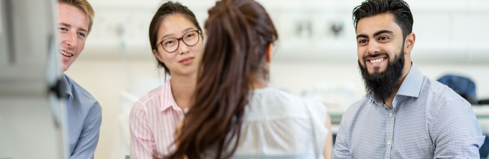 Medicine students sit talking in a group discussion