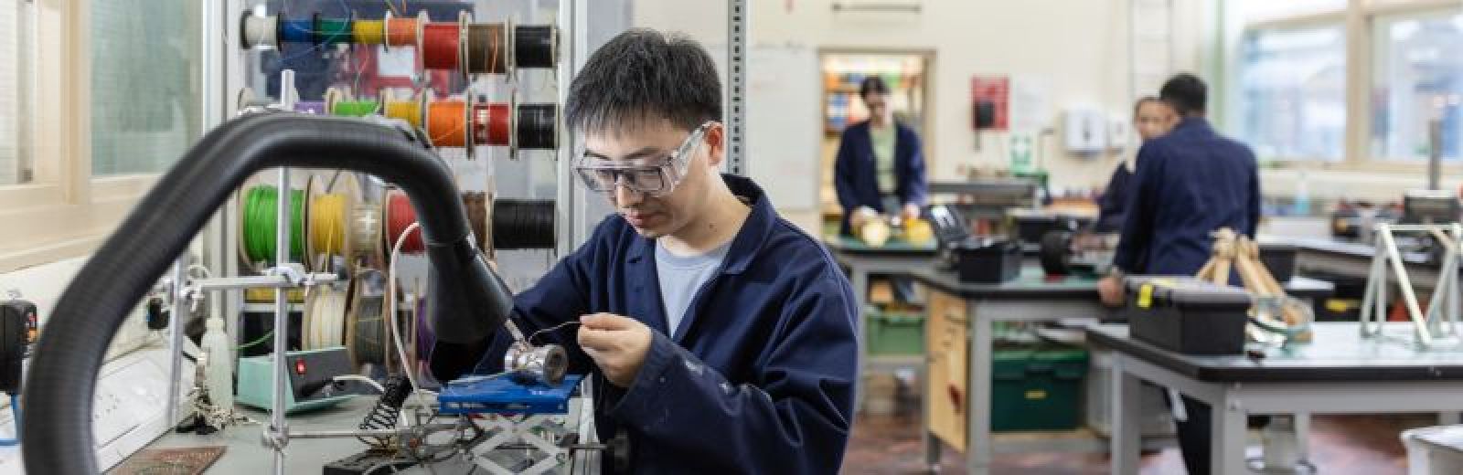 A student is soldering metal together in the prototyping workshop at the University of Leeds.