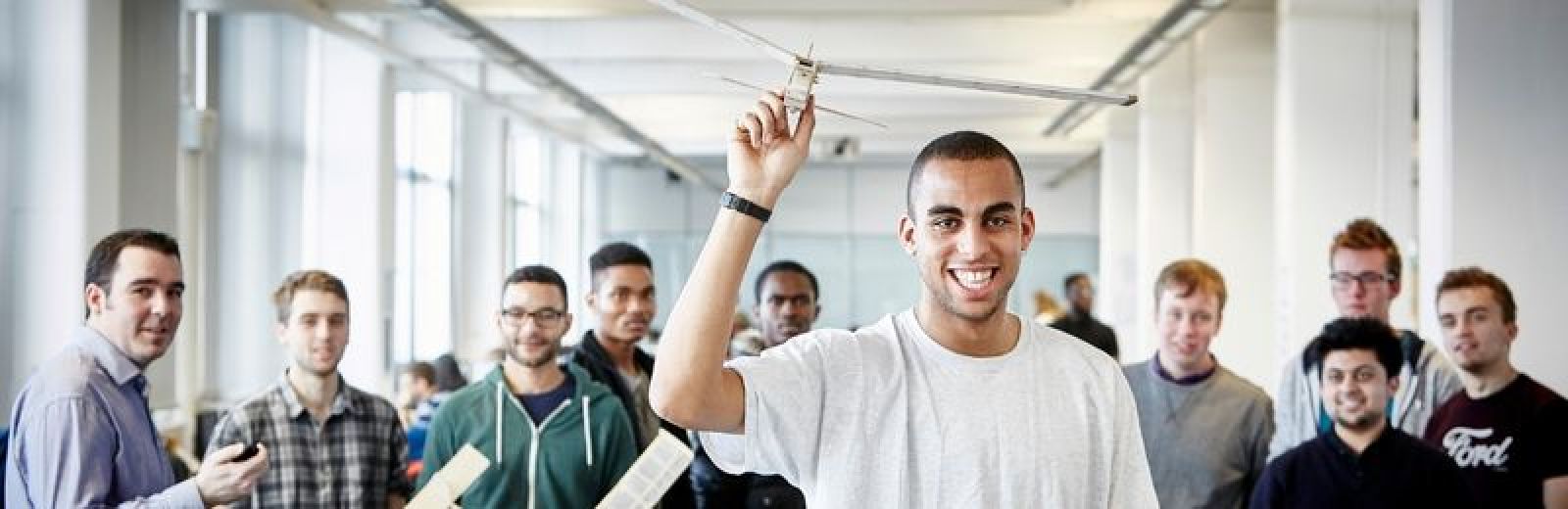 A group of Aeronautical and Aerospace Engineering students holding gliders.