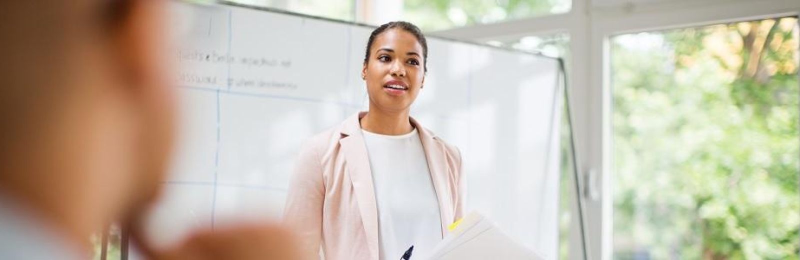 Person standing in front of a whiteboard.