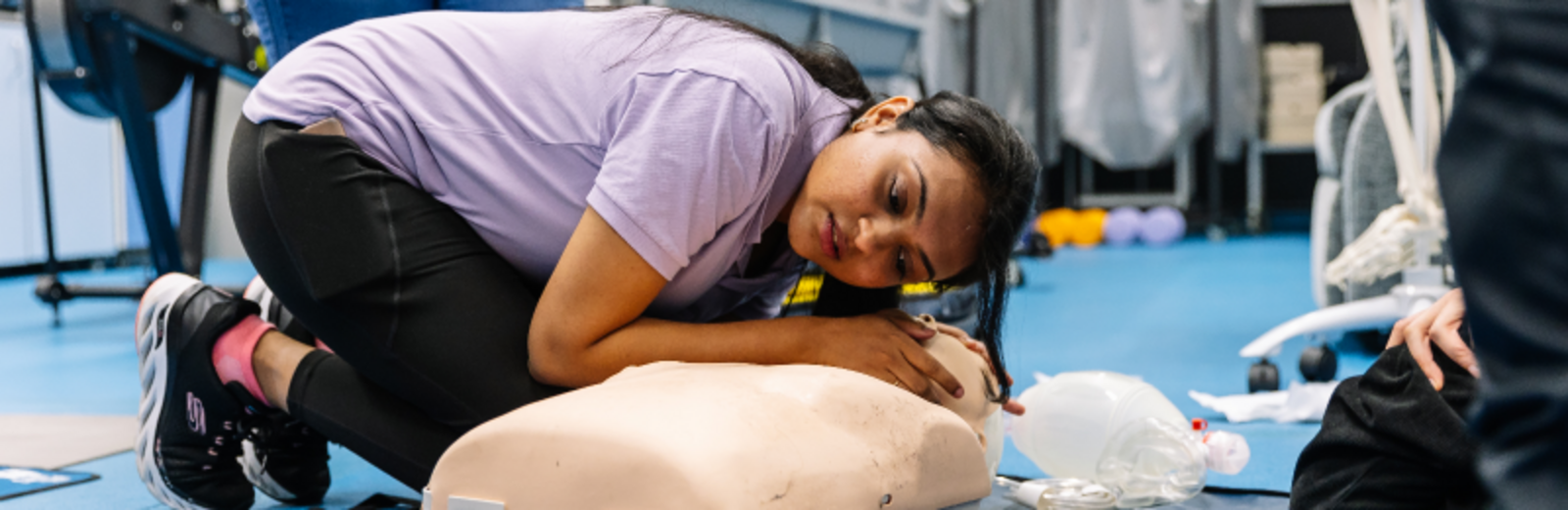 Student offering first aid to model