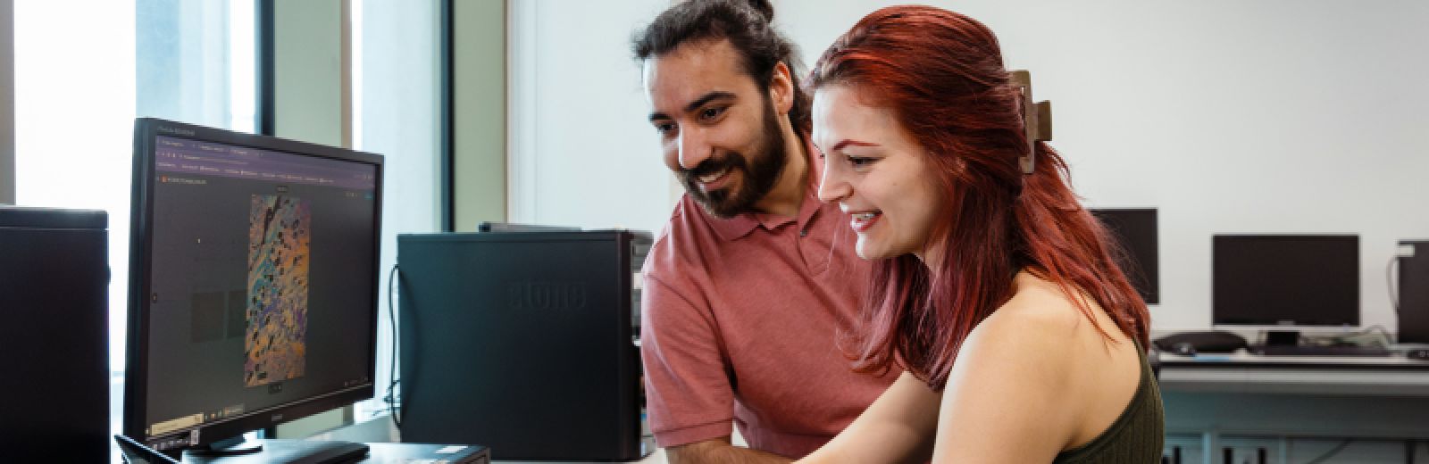 Students looking at a computer screen showing physics coursework