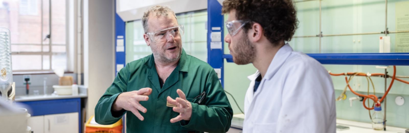 Chemistry technician teaching a student in the lab