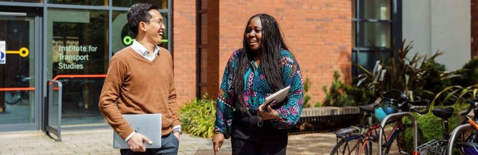 Image of two students chatting outside the Institute for Transport Studies