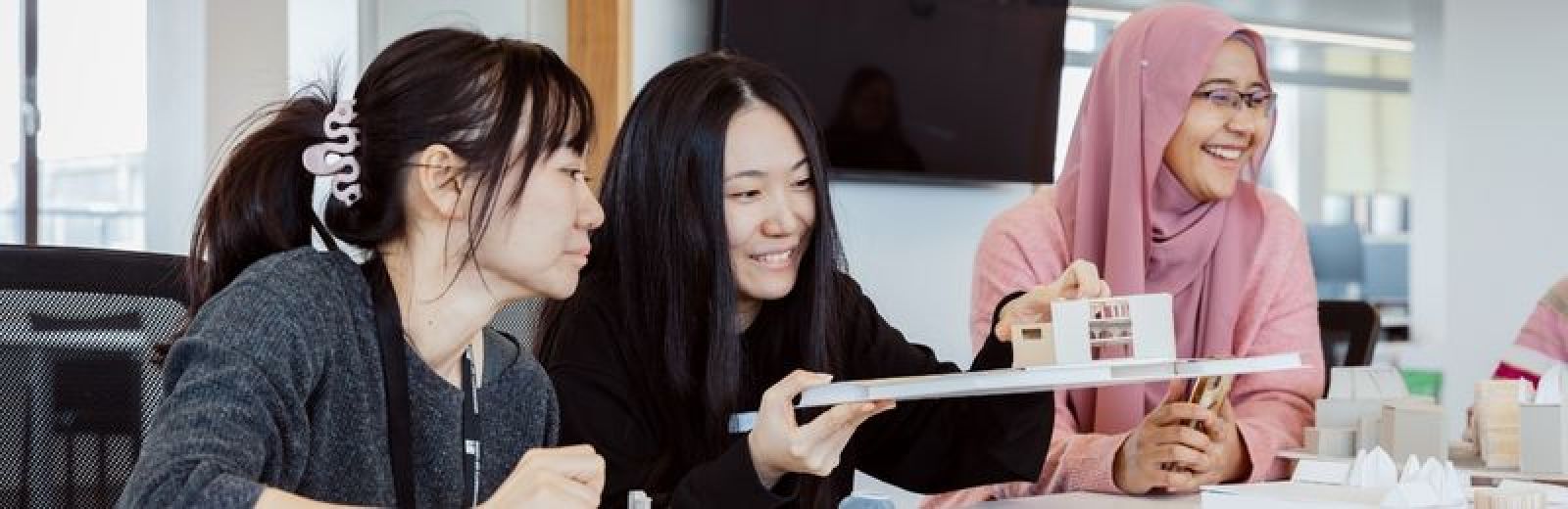 Image of female architecture students holding a model