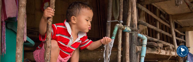boy drinking water from tap