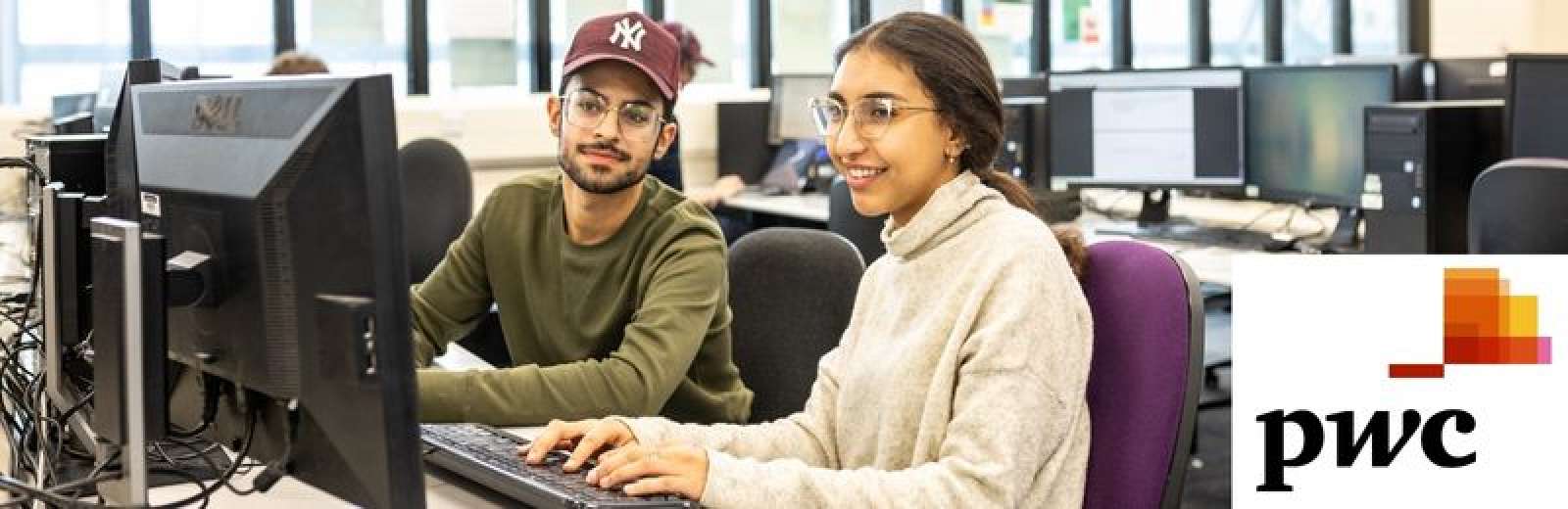 Computing students looking at computer