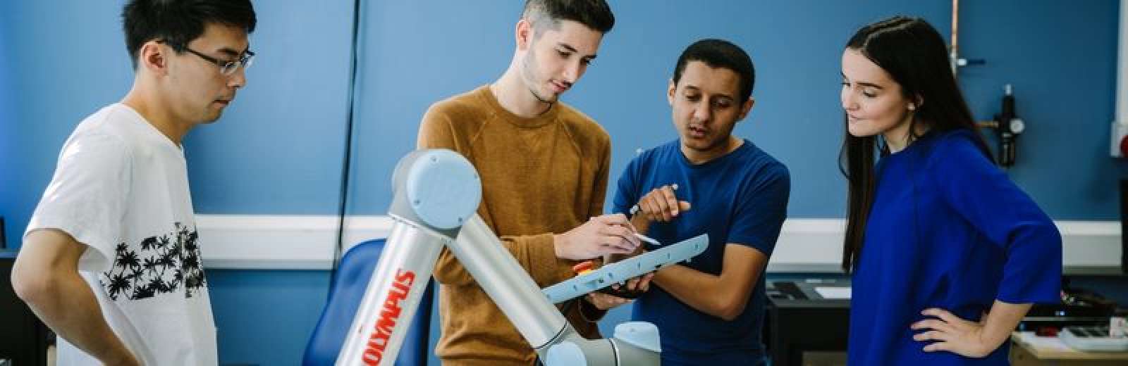 A group of students working in a robotics lab at the University of Leeds.