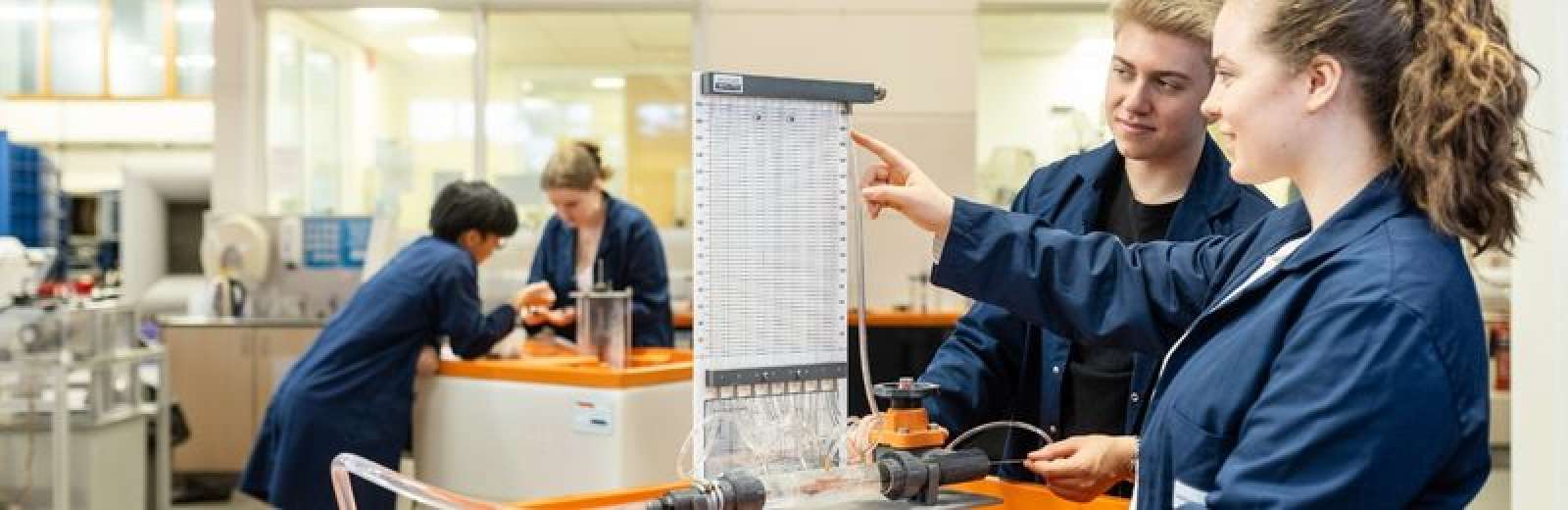 Two students working at a thermo bench in the thermofluids lab at the University of Leeds.
