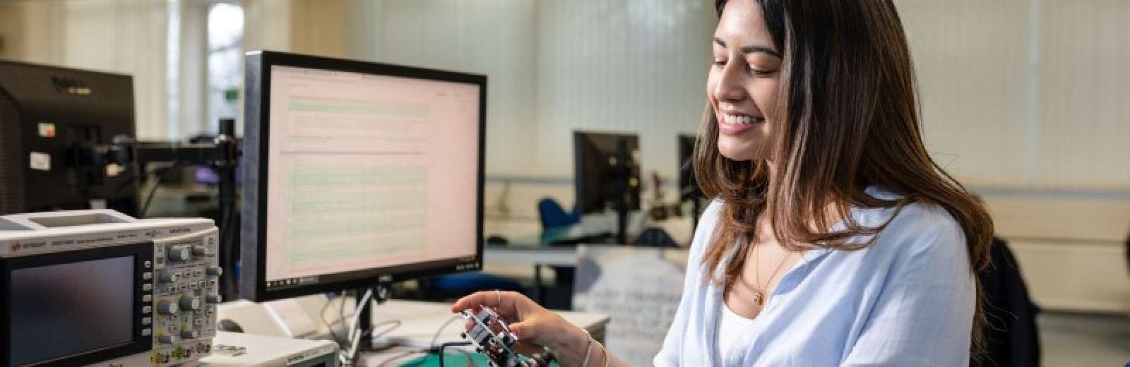 female student working in electronics lab