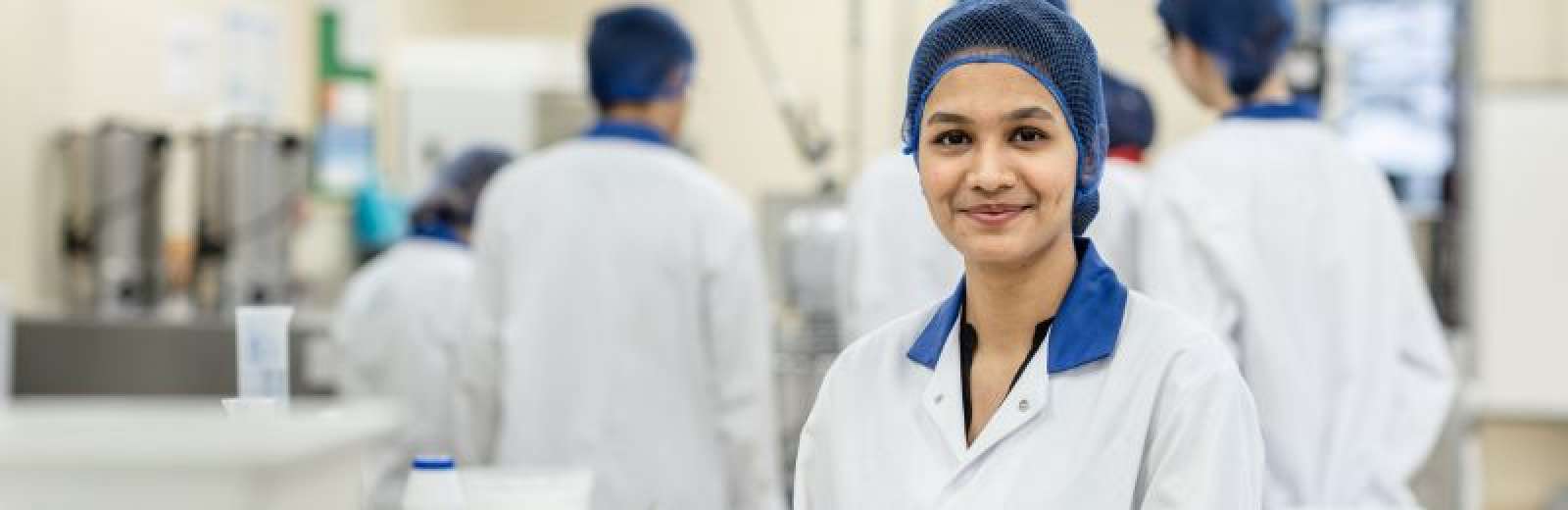 Student smiling at the camera in the Food Technology Laboratory