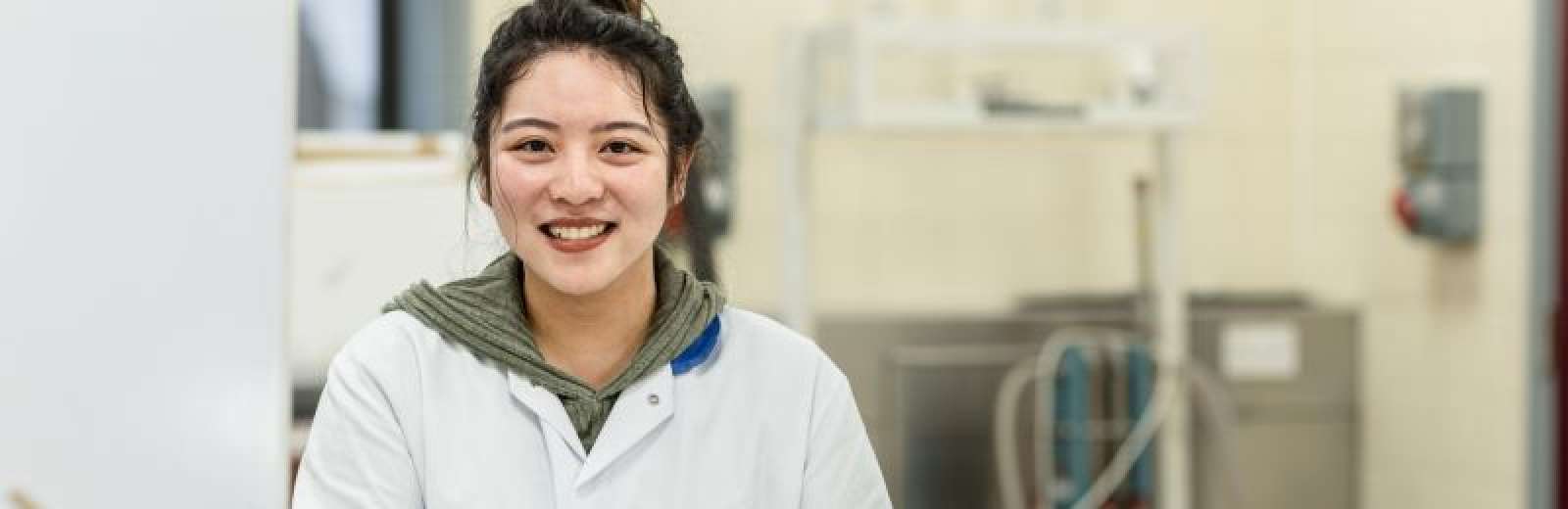 Student smiling at the camera in the Food Technology Laboratory